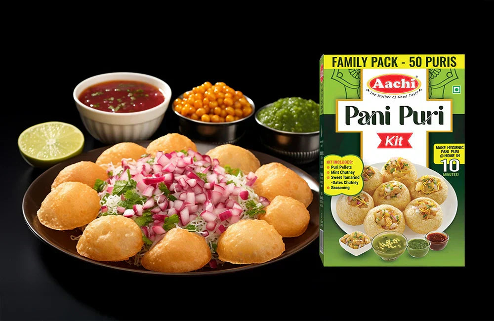 Aachi Pani Puri Kit pack displayed beside a plate of stuffed pani puris with chutneys and garnishes.